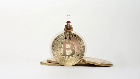 Miniature man sitting on bitcoin. Stock Footage 287898568