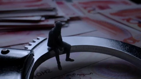 Miniature Man Sitting on Metal Ring Over Currency Bills 動画素材 339068100