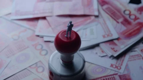 Miniature Man Standing on Red Rubber Stamp Top Amidst Scattered Banknotes Video stock 339068460