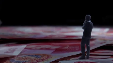Miniature Man Standing on Scattered Red Banknotes, Close-up Stock Footage 339067301
