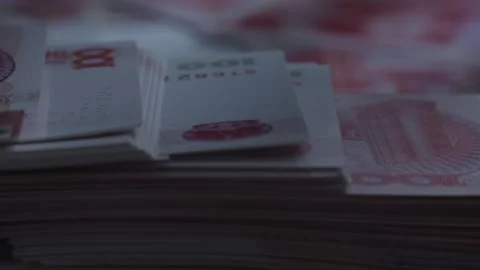Miniature Man Walking Across Stack of Red Chinese Yuan Banknotes Stockbeeldmateriaal 339067826