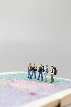 Miniature people Backpacker walking on map Stock Photos