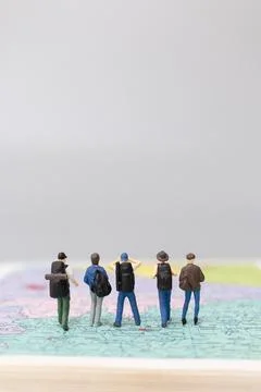Miniature people Backpacker walking on map Stock Photos