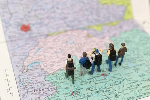Miniature people Backpacker walking on map Stock Photos