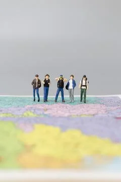 Miniature people Backpacker walking on map Stock Photos