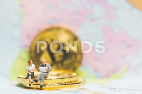 Miniature people: Businessman on stack of coins , business success concept. Stock Photos