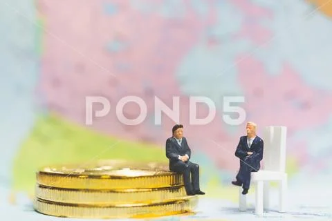 Miniature people: Businessman on stack of coins , business success concept. Stock Photos
