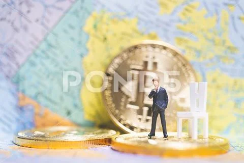 Miniature people: Businessman on stack of coins , business success concept. Stock Photos