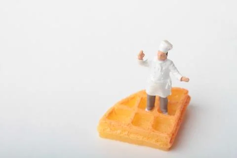 Miniature people: chef preparing some food Stock Photos