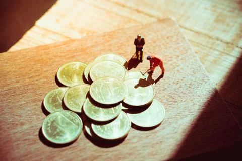 Miniature people, employee working on stack coins Stock Photos