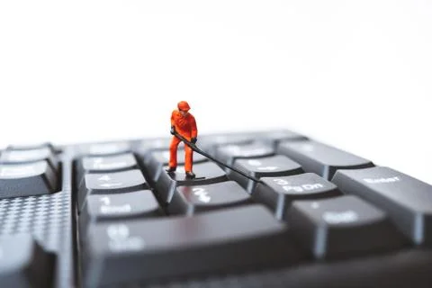 Miniature people, engineer standing on computer keyboard Stock Photos