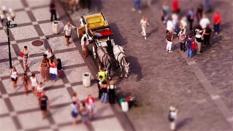 Miniature people getting into Horse Carriage at Old Town Square (tilt-shift) Stock Footage 82700853