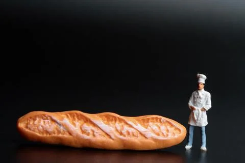 Miniature people: mini chef preparing some food Stock Photos