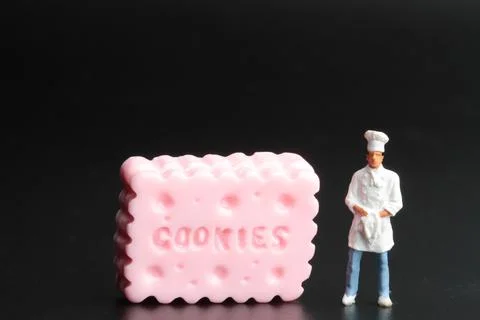Miniature people: mini chef preparing some food Stock Photos