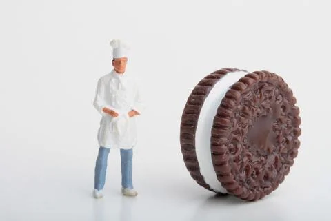 Miniature people: mini chef preparing some food Stock Photos
