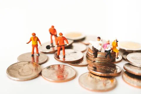 Miniature people, technician working on stack coins Stock Photos