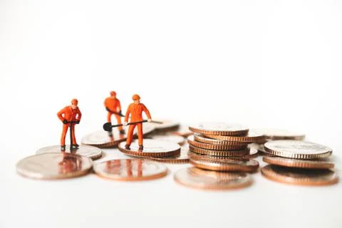 Miniature people, technician working on stack coins Stock Photos