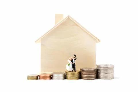 Miniature people wedding on stack coins  on white background. Stock Photos