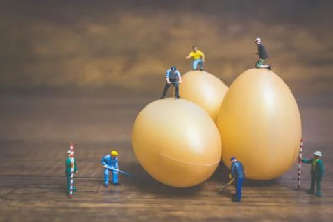 Miniature people work at Easter-eggs for Easter day Foto stock