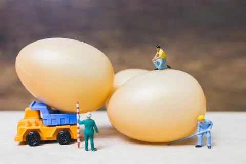 Miniature people work at Easter-eggs for Easter day Stock Photos