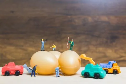 Miniature people work at Easter-eggs for Easter day Stock Photos