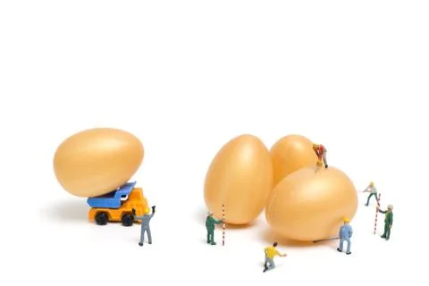 Miniature people work at Easter-eggs for Easter day 写真素材