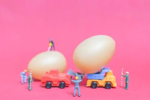 Miniature people work at Easter-eggs for Easter day Stock Photos