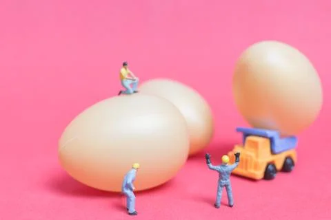 Miniature people work at Easter-eggs for Easter day Stock Photos