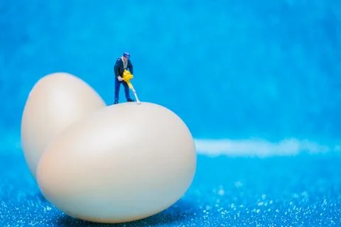Miniature people work at Easter-eggs for Easter day Stock Photos
