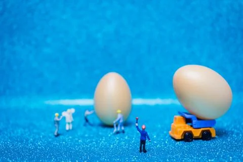 Miniature people work at Easter-eggs for Easter day Stock Photos