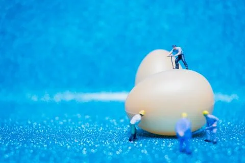 Miniature people work at Easter-eggs for Easter day Stock Photos