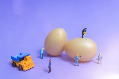 Miniature people work at Easter-eggs for Easter day Stock Photos