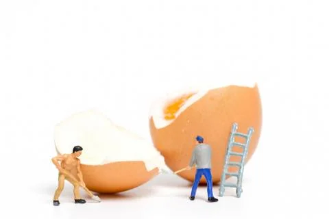 Miniature people work at Easter-eggs for Easter day Foto stock