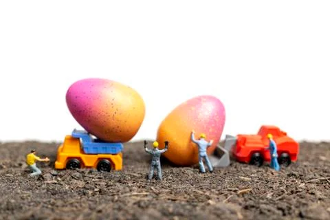Miniature people work at Easter-eggs for Easter day 写真素材