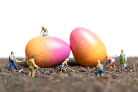 Miniature people work at Easter-eggs for Easter day Stockfoto's