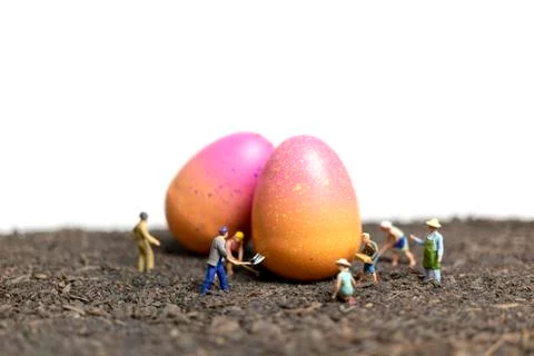 Miniature people work at Easter-eggs for Easter day Foto stock