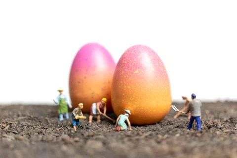Miniature people work at Easter-eggs for Easter day Stockfoto's