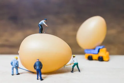 Miniature people work at Easter-eggs for Easter day Stock Photos
