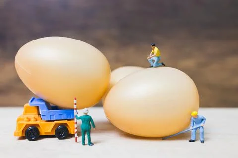 Miniature people work at Easter-eggs for Easter day Stock Photos