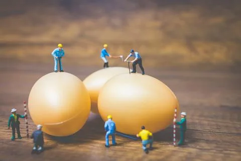 Miniature people work at Easter-eggs for Easter day Stock Photos