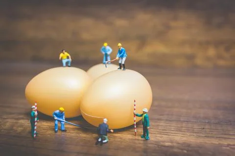 Miniature people work at Easter-eggs for Easter day Stock Photos