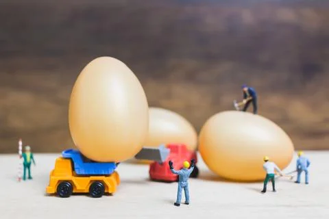 Miniature people work at Easter-eggs for Easter day Stock Photos
