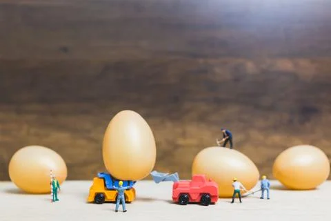 Miniature people work at Easter-eggs for Easter day Stock Photos