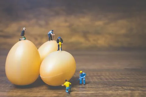 Miniature people work at Easter-eggs for Easter day Stock Photos