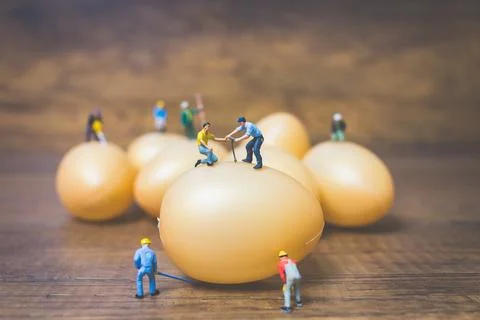 Miniature people work at Easter-eggs for Easter day Stock Photos