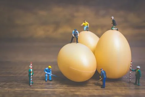 Miniature people work at Easter-eggs for Easter day Stock Photos