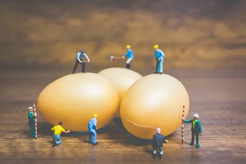 Miniature people work at Easter-eggs for Easter day Stock Photos