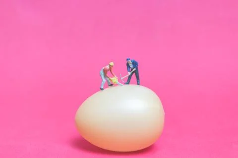 Miniature people work at Easter-eggs for Easter day Stock Photos