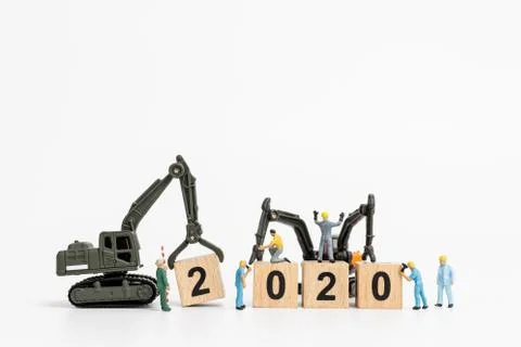 Miniature people : Worker team create wooden block number 2020 Stock Photos