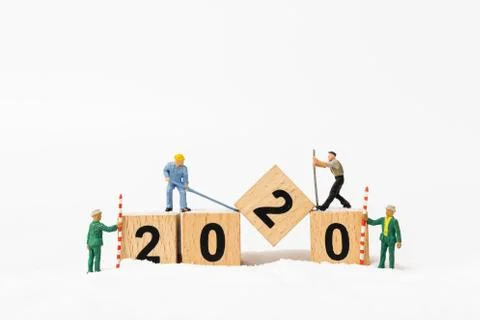 Miniature people : Worker team create wooden block number 2020 Stock Photos